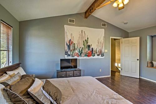 a bedroom with a bed and a painting on the wall at Lago Vista Lake Home with Shared Dock and Kayaks! in Lago Vista