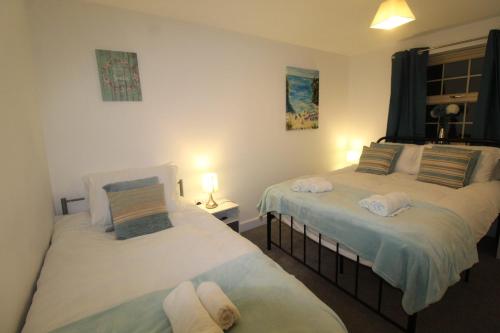 a bedroom with two beds and a lamp in it at Pavement House in Sutton in Ashfield