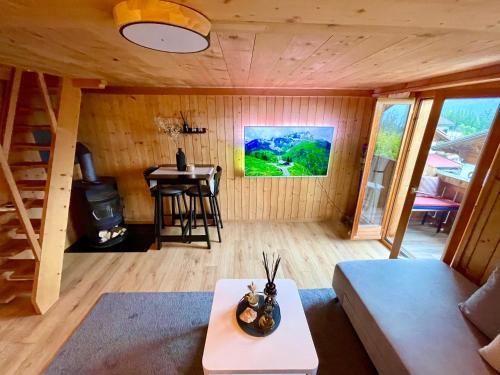 ein Wohnzimmer mit einem Sofa und einem Tisch in einer Hütte in der Unterkunft Charmant Chalet mit See und Bergsicht in Hofstetten 