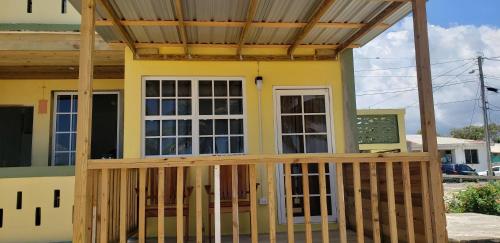 a house with a porch with a roof at Pal's on the beach - Dangriga, Belize in Dangriga