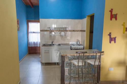 a kitchen with blue walls and a sink and a counter at Casa en Cafayate in Cafayate
