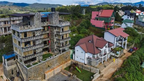 an aerial view of an old building with houses at Fort WindShire in Nuwara Eliya