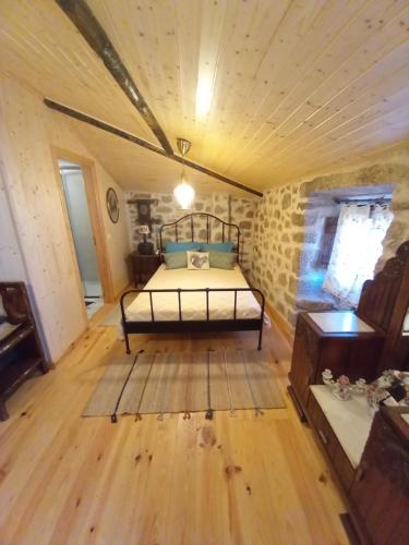 ein Schlafzimmer mit einem Bett in der Mitte eines Zimmers in der Unterkunft Casa da Ti Maria Pereira in Monsanto