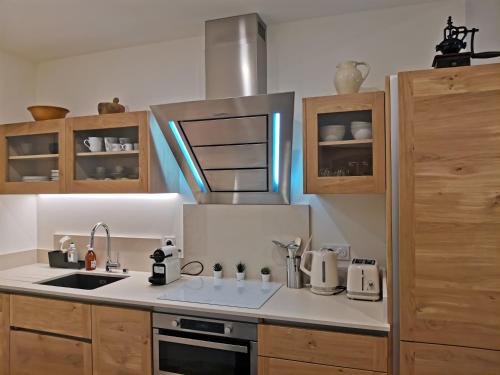 a kitchen with a sink and a stove top oven at L'oustaou d'Arles in Arles