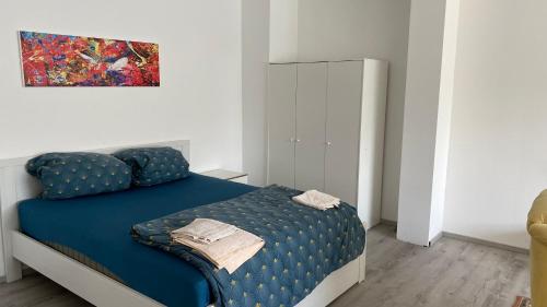 a bedroom with a blue bed and a cabinet at Pension Neon in Mannheim