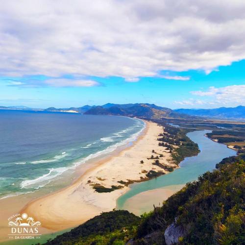 an aerial view of a beach next to the ocean at Pousada Dunas da guarda in Guarda do Embaú