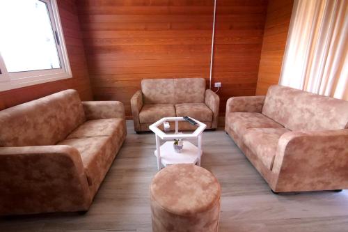 a living room with two couches and a table at Bujtina e Muriqit in Shkodër