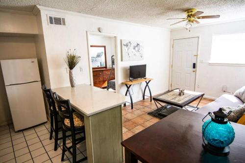 a kitchen and living room with a refrigerator and a table at Central Automobile Alley Modern 1BDR - WIFI in Oklahoma City