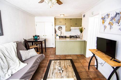 a living room with a couch and a table at Central Automobile Alley Modern 1BDR - WIFI in Oklahoma City