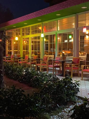 a restaurant with tables and chairs at night at OFURO WORLD HOTEL SPA in Izmir