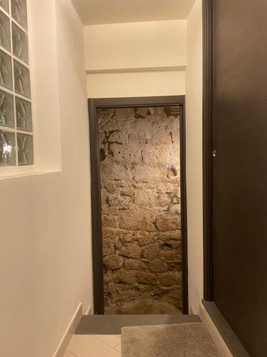 a door into a room with a stone wall at Il Nido Etrusco in Orvieto