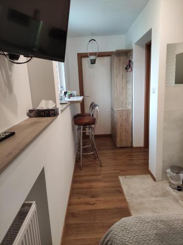 a living room with a table and a chair at Homestay Stróżówka in Gorlice