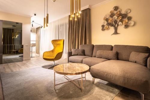 a living room with a couch and a table at Aparthotel NOX in Cluj-Napoca
