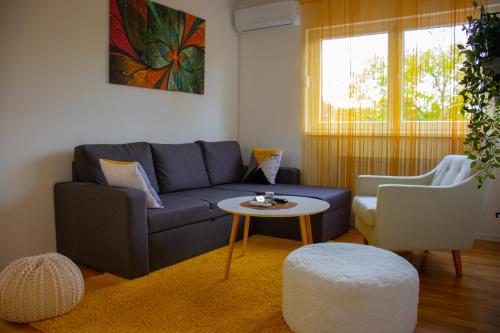 a living room with a blue couch and a table at Exclusive apartment Visoko in Visoko