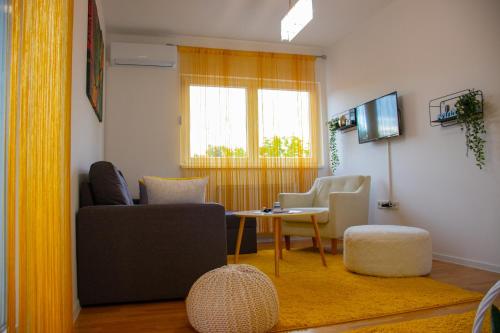 a living room with a couch and a table and chairs at Exclusive apartment Visoko in Visoko