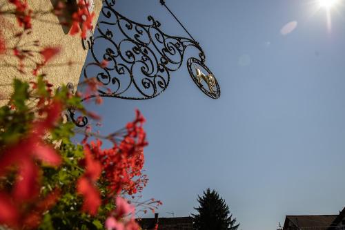 a view of the sun with a clock in the sky at Landgasthof & Brauerei Löwen Sasbach in Sasbach in der Ortenau