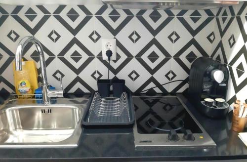 eine Küchentheke mit einer Spüle und einem Mixer in der Unterkunft Aldeia Studio Albufeira in Albufeira
