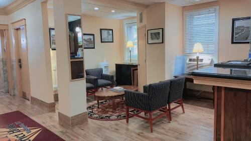 a living room with chairs and a table in a room at District Hotel in Washington, D.C.