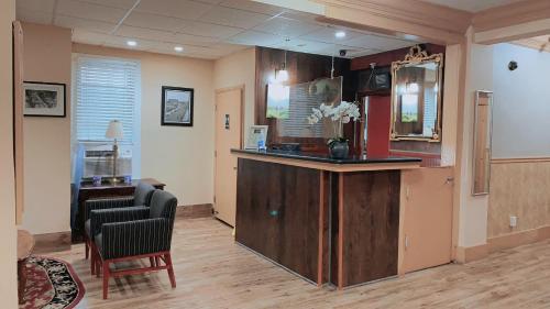 a waiting room with a bar and two chairs at District Hotel in Washington, D.C.