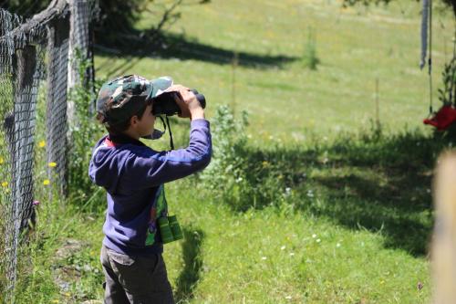 a young boy taking a picture with a camera at Nature Space Jabugo in Jabugo