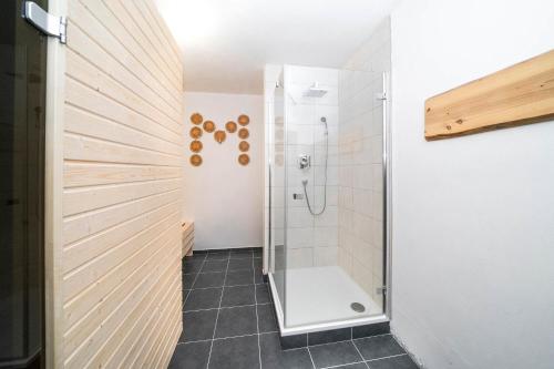 a bathroom with a shower with a glass door at Penzion U Churáňů in Stachy