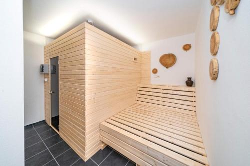 a sauna in a bathroom with a wooden wall at Penzion U Churáňů in Stachy
