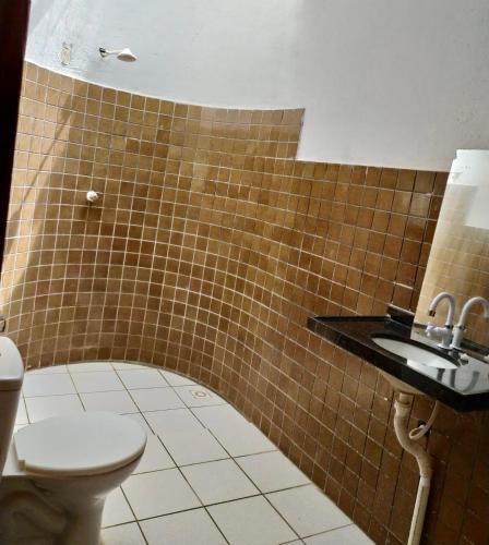 a bathroom with a toilet and a sink at Casa de Praia no Morro Branco in Beberibe
