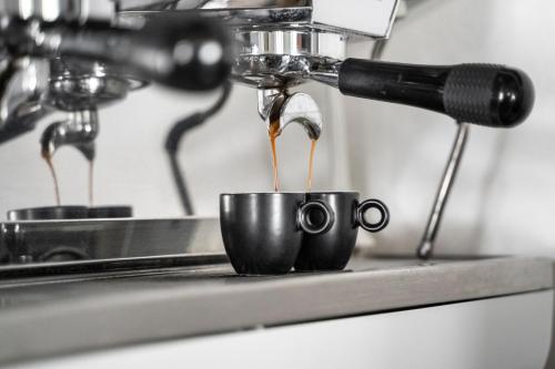 a coffee maker is making coffee in a cup at Penzion U Churáňů in Stachy