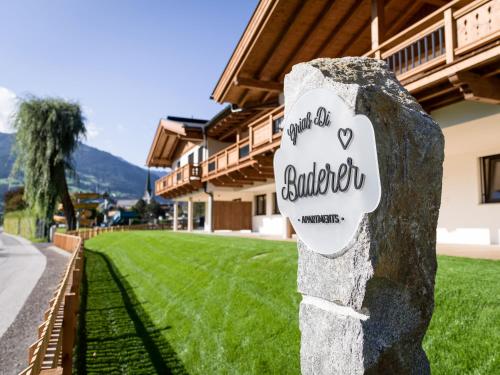 a sign on a rock in front of a house at Baderer Apart in Stumm
