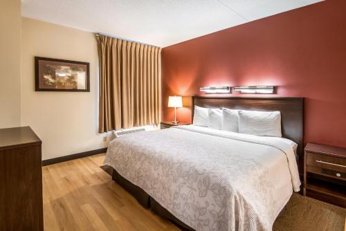 a hotel room with a large bed and a window at Red Roof Inn PLUS+ South Deerfield - Amherst in South Deerfield
