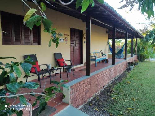 a porch of a house with chairs on it at Quinta Flor-de-Lis in Serra de São Bento