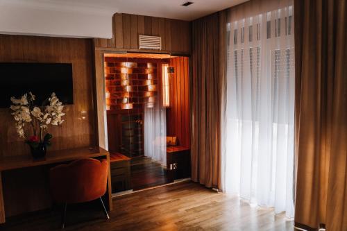 a room with a desk and a wine cellar at Hotel Glory in Oradea