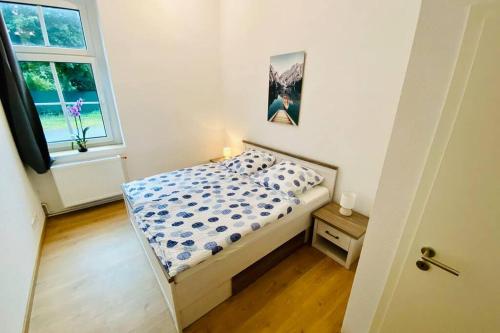 a small bedroom with a bed and a window at FeWo Seenest in Goslar