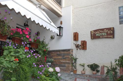 a building with flowers on the side of it at Akrotiri Hotel in Neos Marmaras