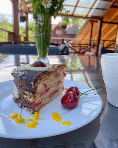a piece of cake on a plate on a table at Georgiy in Oryavchyk
