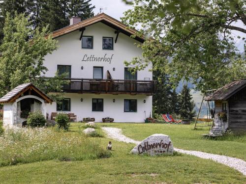 a large white house with a balcony on it at Lettnerhof Bnb Wohnung 3 in Monguelfo