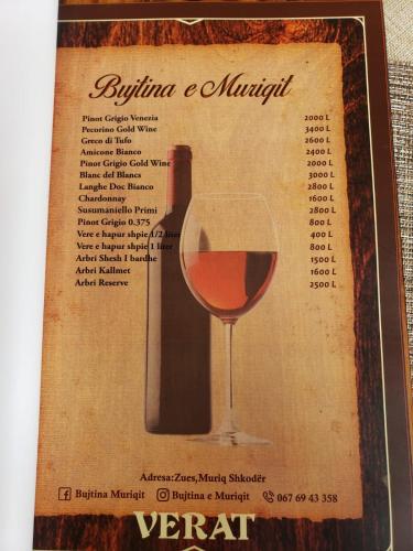 a poster of a glass of red wine at Bujtina e Muriqit in Shkodër