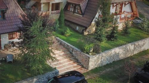 an aerial view of a house with a stone retaining wall at SVETLA U PLANINI in Bajina Bašta