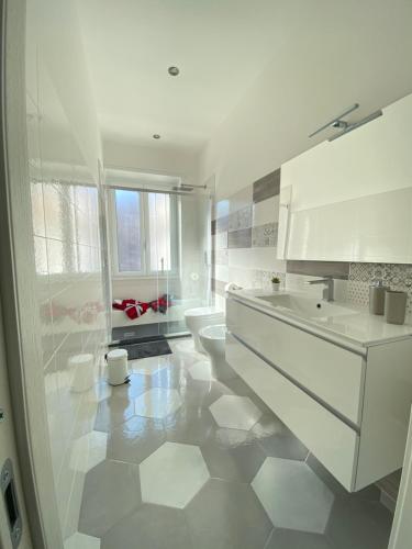 a white bathroom with two sinks and a toilet at Gaeta, B&B la Loggia in Gaeta