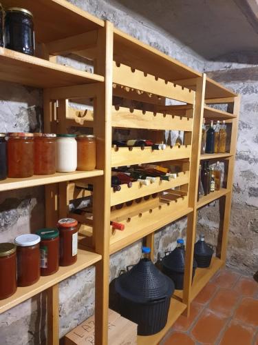 a shelf filled with lots of bottles and jars at Medjedovica Brdo Godovik in Godovik