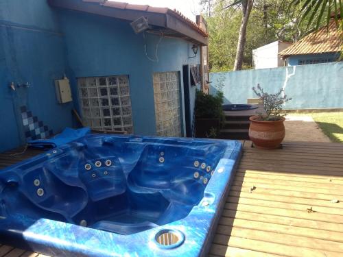 a blue hot tub sitting on a deck at Pousada Canto dos Passaros in Chapada dos Guimarães