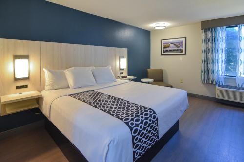 a hotel room with a large bed and a window at Best Western Plus Lafayette Hotel University Area in Lafayette