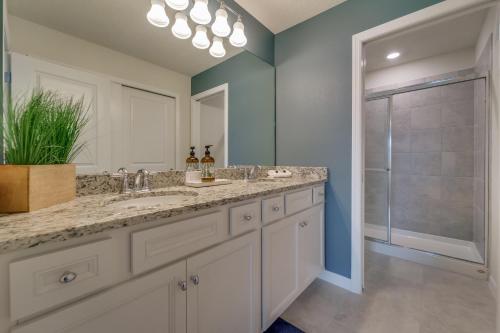 a bathroom with two sinks and a large mirror at Windsor Island Resort 5 Bedroom Townhome Private Pool Disney in Davenport