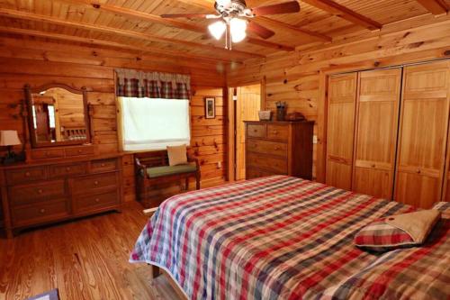 a bedroom with a bed in a wooden cabin at The Crows Nest in Lake Lure