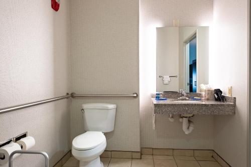 a bathroom with a toilet and a sink at Holiday Inn Express Hotel & Suites Evanston by IHG in Evanston