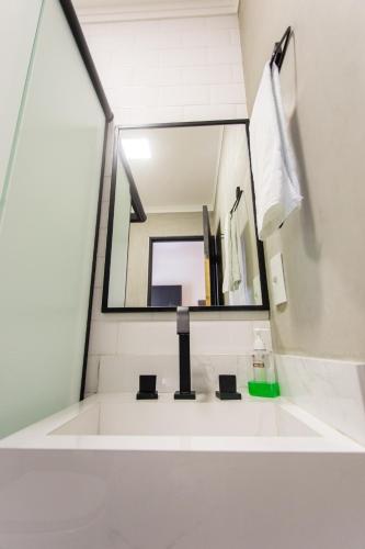 a bathroom with a sink and a mirror at Hostel More SP in Sao Paulo