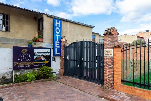 a building with a gate and a hotel sign at Ayenda Puerto Madero Boutique in Chía
