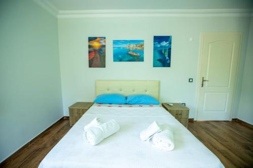 a bedroom with a large white bed with blue pillows at The Doctor's House in Sapanca