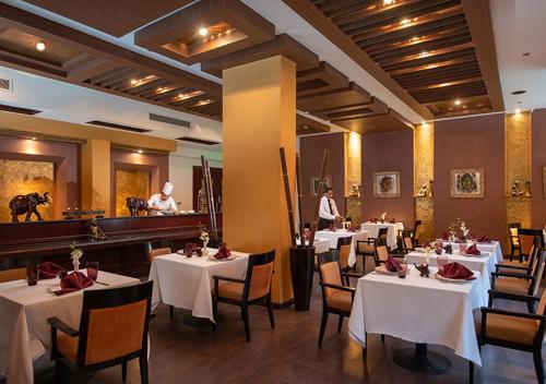 a dining room with tables with white tablecloths at Premier Le Reve Hotel & Spa Sahl Hasheesh - Adults Only 16 Years Plus in Hurghada