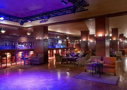 a lobby with a bar with chairs and tables at Premier Le Reve Hotel & Spa Sahl Hasheesh - Adults Only 16 Years Plus in Hurghada